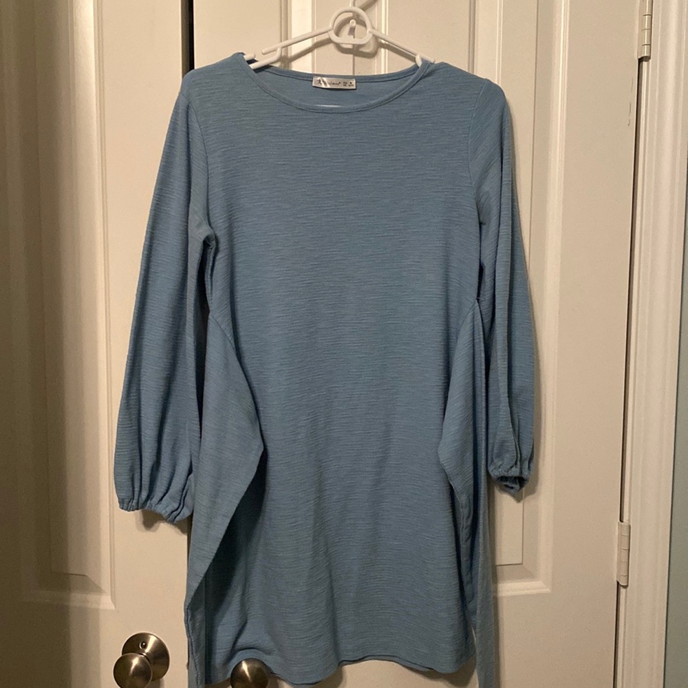 A blue of some sort tunic with sash